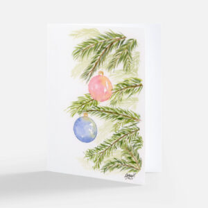 Watercolor Christmas notecard of a pink and a blue ornament hanging from green evergreen branches